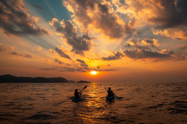 female-and-male-sailing-with-canoes-close-to-each-other-at-sunset (1)